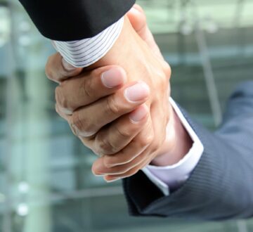 Handshake of businessmen, panoramic banner background with copy space