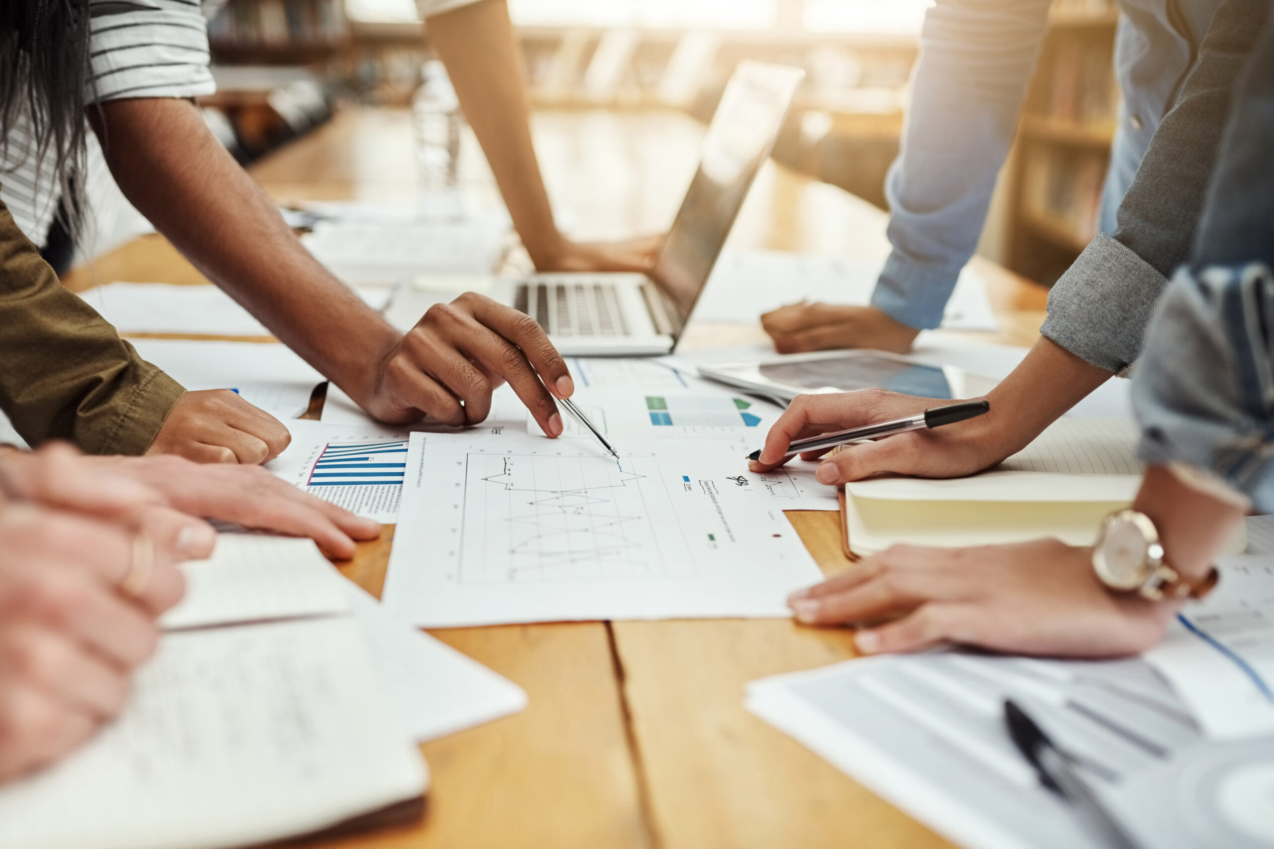 Business people, collaboration and paperwork with hands, statistics and social media trends. Office, writing and review of content creation team with SEO and target audience info for web update
